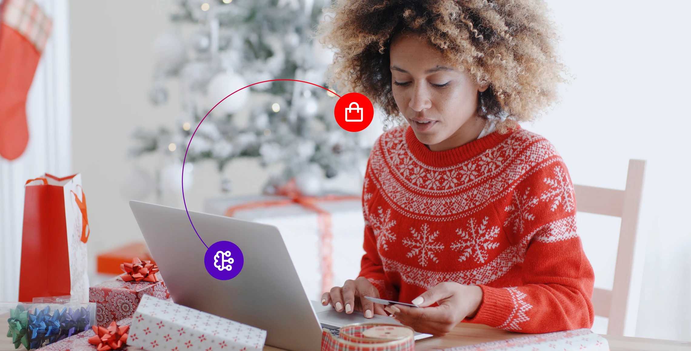 Woman dressed in a red Christmas jumper using the computer for AI holiday shopping assistance